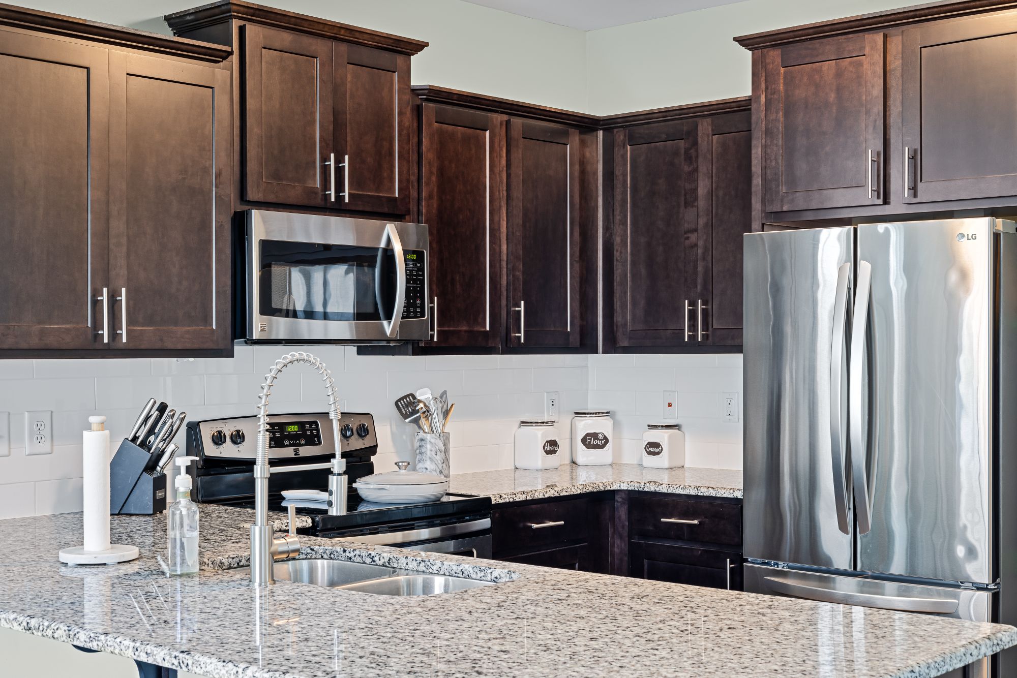 Two-tone custom kitchen with full-height rift oak storage in Forest Hill